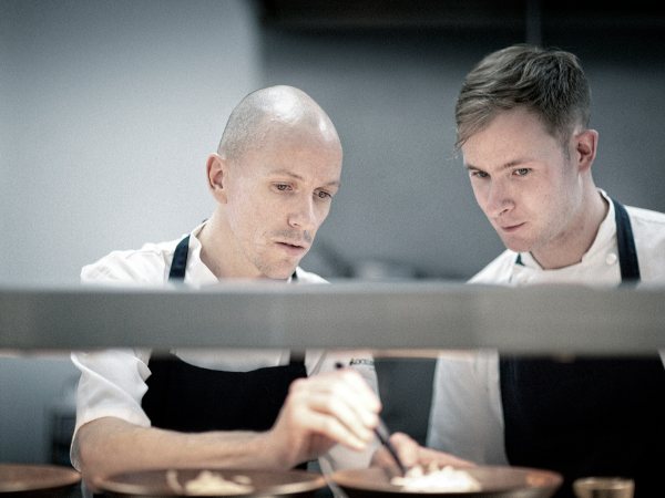 Ian Godfrey and a colleague working the pass in a fine dining kitchen
